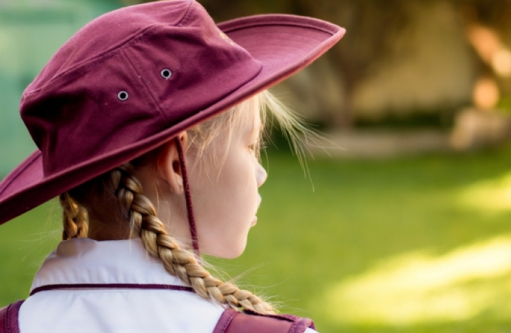 School child wearing hat